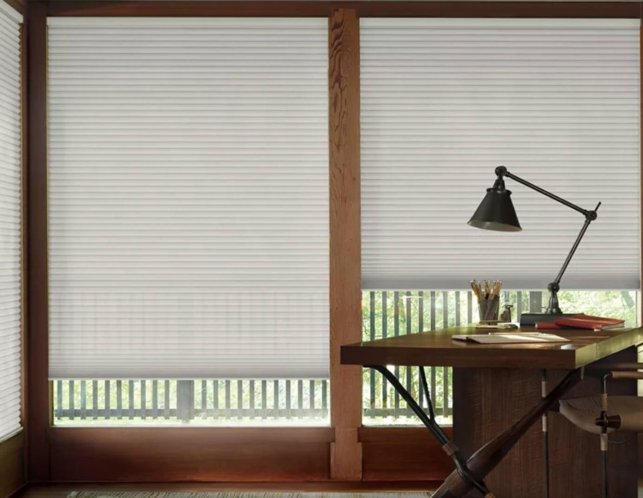 Hunter Douglas Duette® Cellular Shades in a home office with desk, lamp, and books at Beaufort Blind & Shutter Shoppe near Beaufort, NC